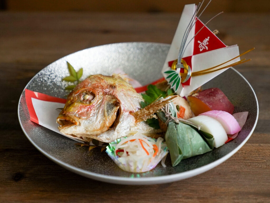 Whole sea bream on a celebration tray with noshi and red-and-white mizuhiki