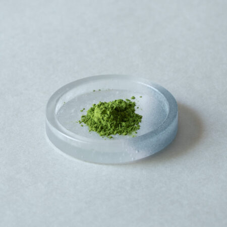 Stone-milled matcha powder on a glass dish