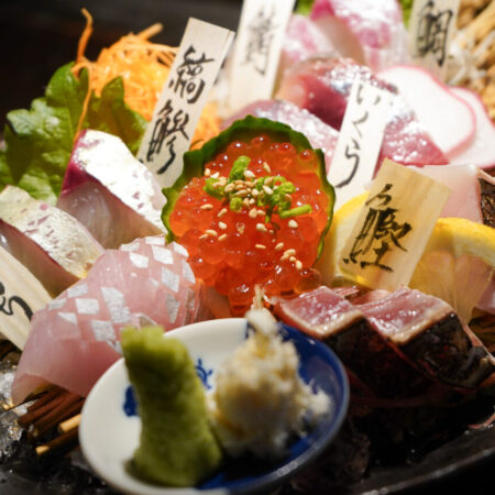 Japanese sashimi platter with wooden name tags for each fish